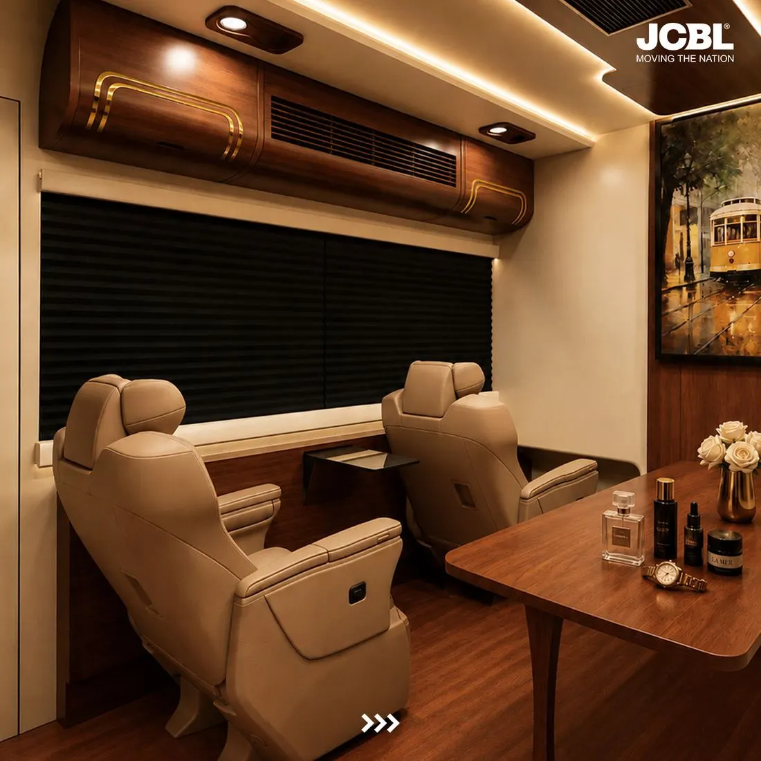 Two reclining captain seats with a fold-away table inside the JCBL motorhome lounge