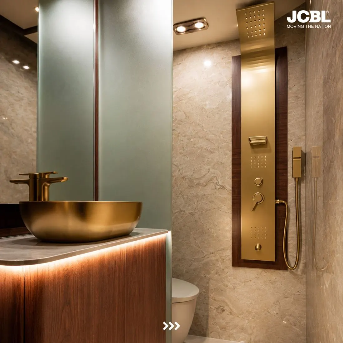 Washroom with marble walls, gold basin and rain shower panel